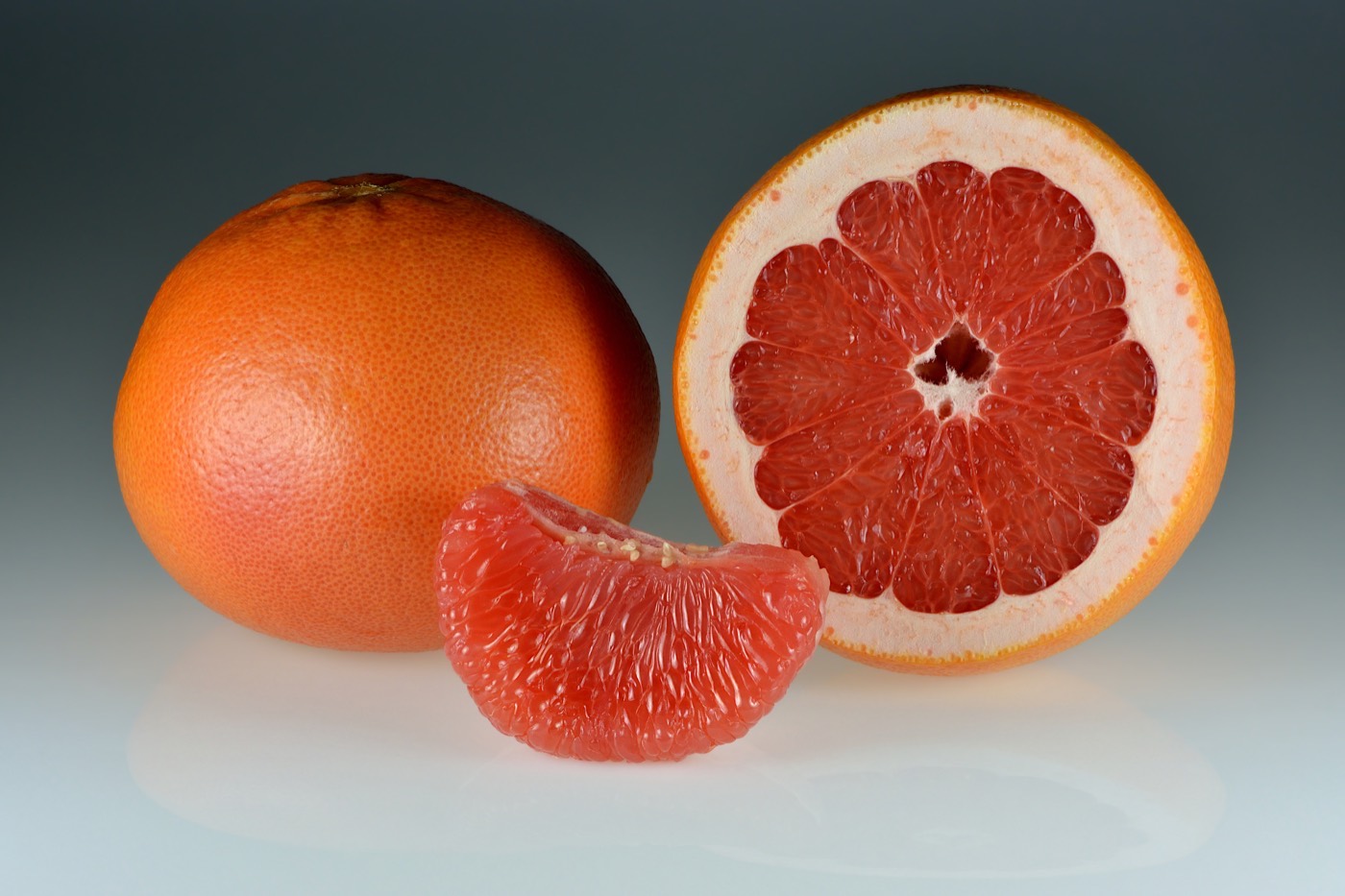 Whole, halved, and segmented grapefruits