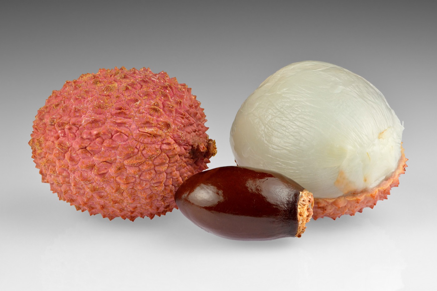 Lychee fruits with peeled flesh and seed visible