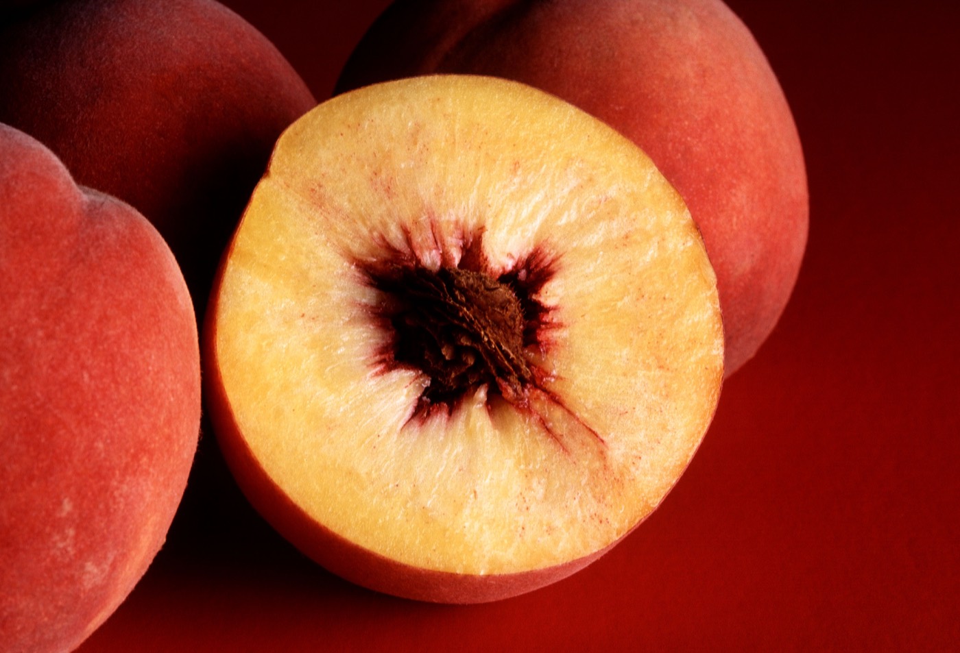Ripe red peaches photographed in sunlight