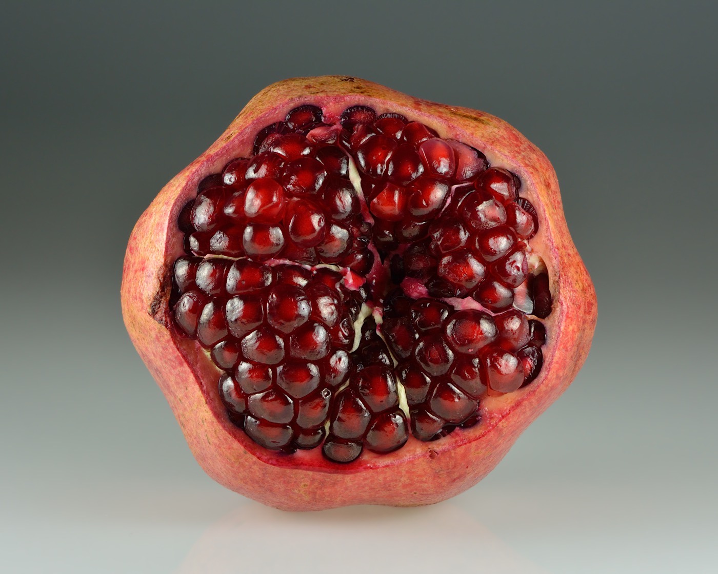 An opened pomegranate showing red arils