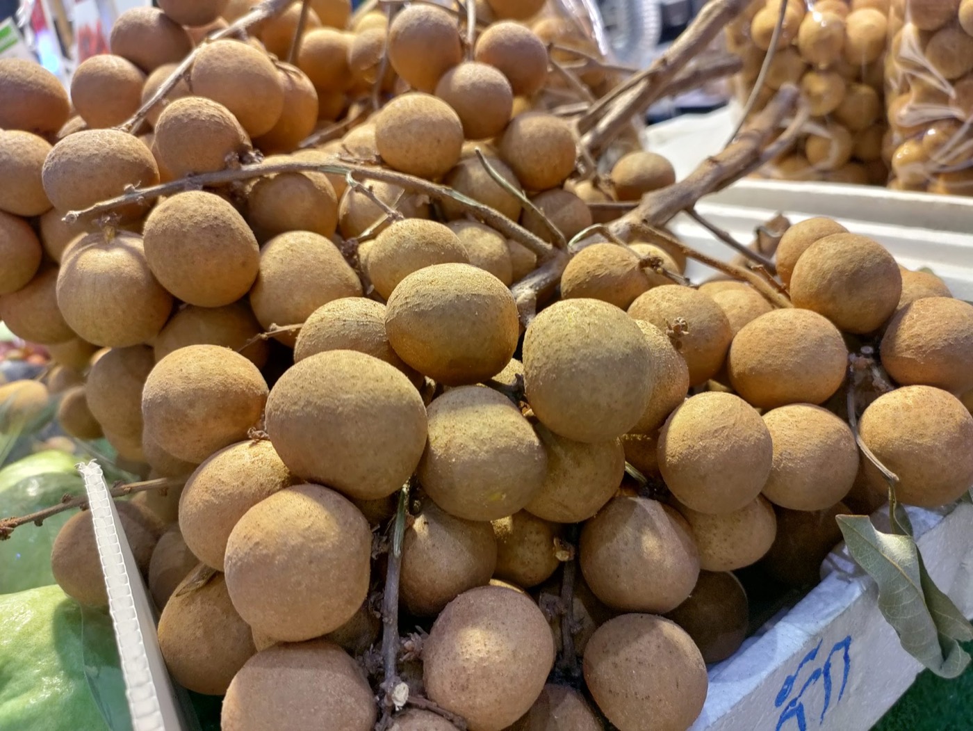 A cluster of longan fruit on the branch