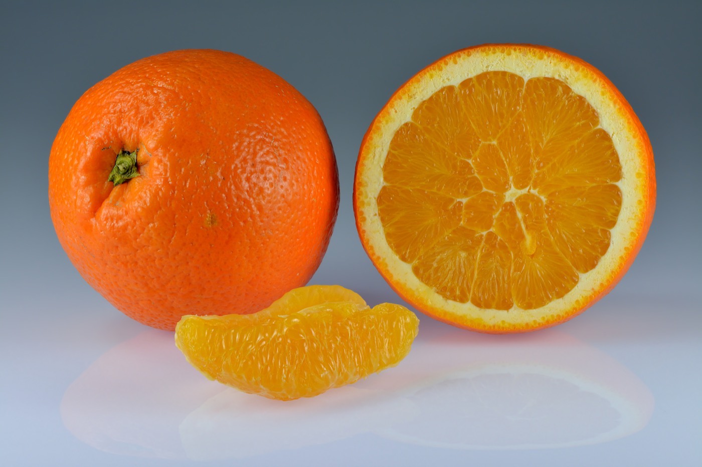 Whole, halved, and segmented oranges